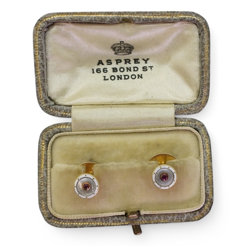 2799 - A PAIR OF ASPREY'S SHIRT STUDSmade in 18ct yellow gold, with a central ruby, set into mother of pear... 