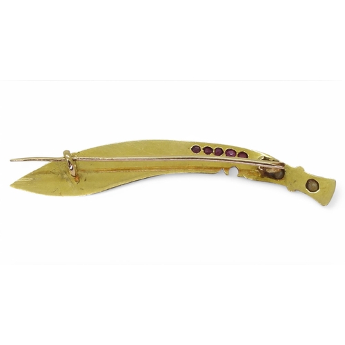 727 - A bright yellow metal Arabic knife shaped brooch set with rubies and pearls, length 5.5cm, weight 3.... 