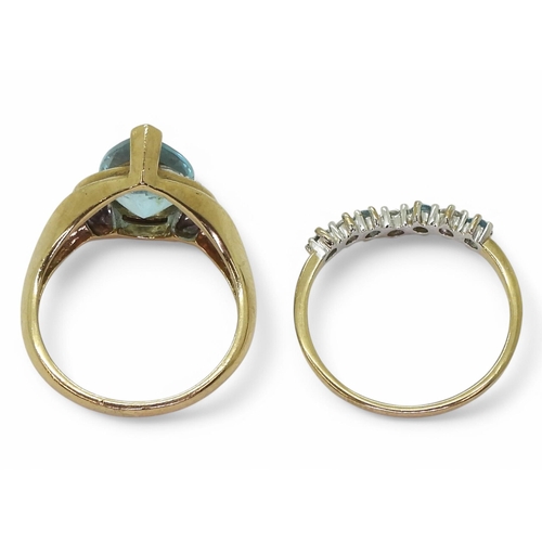 748 - A pair of 9ct gold rings set with light blue topaz, clear gems and diamond accents, L and L1/2, weig... 