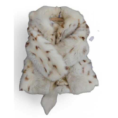 222 - A white spotted fox fur coat, an ermine stole, a long dark brown fur coat, two hats, two short fur c... 