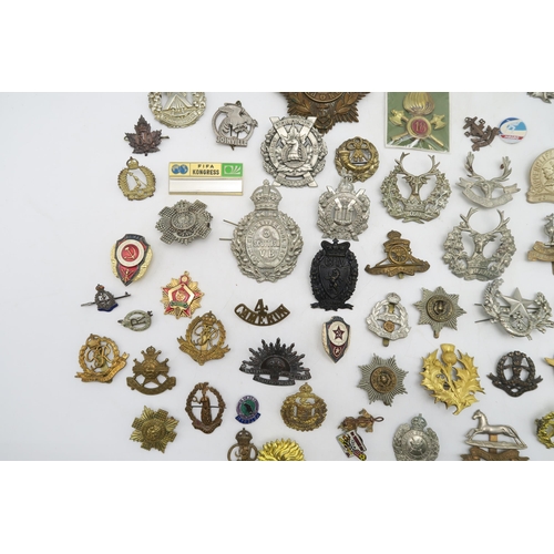 379 - Assorted military cap and uniform badges, to include a Royal Marines Gibraltar helmet plate, King's ... 