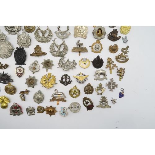 379 - Assorted military cap and uniform badges, to include a Royal Marines Gibraltar helmet plate, King's ... 