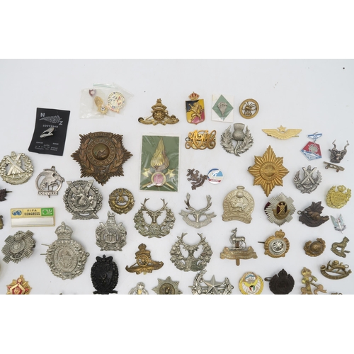 379 - Assorted military cap and uniform badges, to include a Royal Marines Gibraltar helmet plate, King's ... 