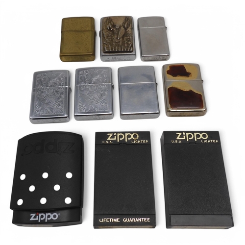 489 - A small collection of Zippo lighters, to include an example with applied enamel West Ham United Upto... 