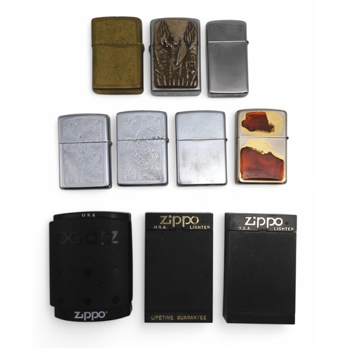 489 - A small collection of Zippo lighters, to include an example with applied enamel West Ham United Upto... 