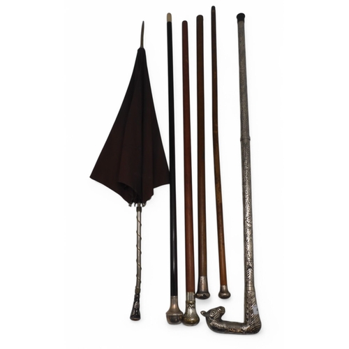 498 - A rosewood walking cane with Birmingham silver top and horn ferule, two further silver-topped canes,... 