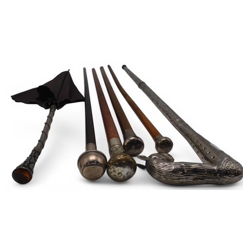 498 - A rosewood walking cane with Birmingham silver top and horn ferule, two further silver-topped canes,... 