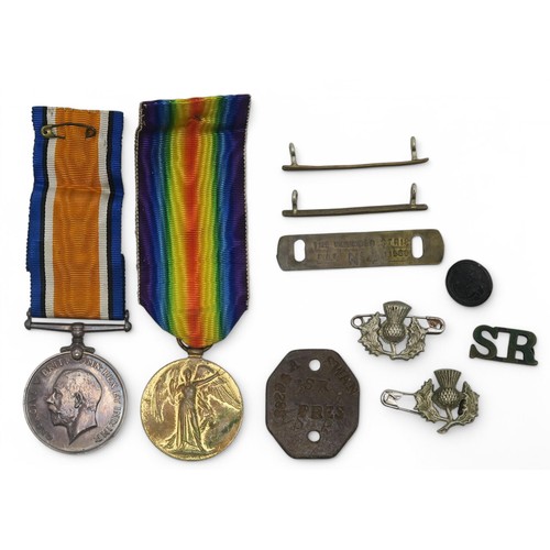 391B - A WW1 medal pair awarded to 38294 Pte. A. Swan, Scottish Rifles, with dog tag and badges