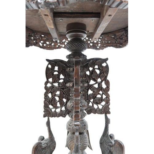 2039B - AN EARLY 20TH CENTURY BURMESE HARDWOOD TILT TOP TABLEcircular carved top with carved/pierced foliate... 