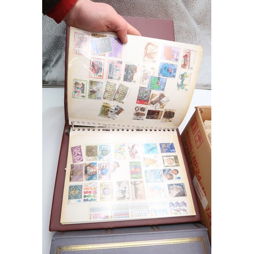 500A - WORLD STAMPS; a collection of three stamp albums, loose stamps and a box of card backed stamps 