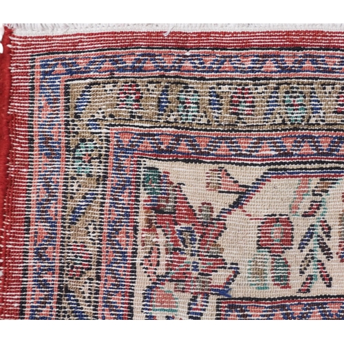 3 - A red ground Hamadan rug with cream and blue central medallion and matching spandrels on floral patt... 