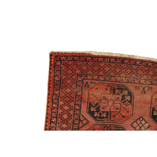 15 - A terracotta ground Afghan rug with all-over geometric lozenge patterned ground within geometric bor... 