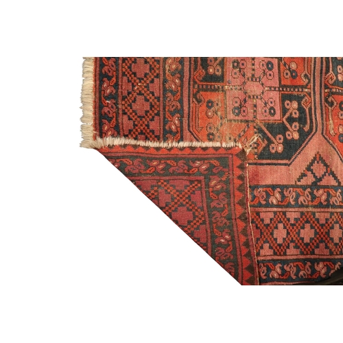 15 - A terracotta ground Afghan rug with all-over geometric lozenge patterned ground within geometric bor... 