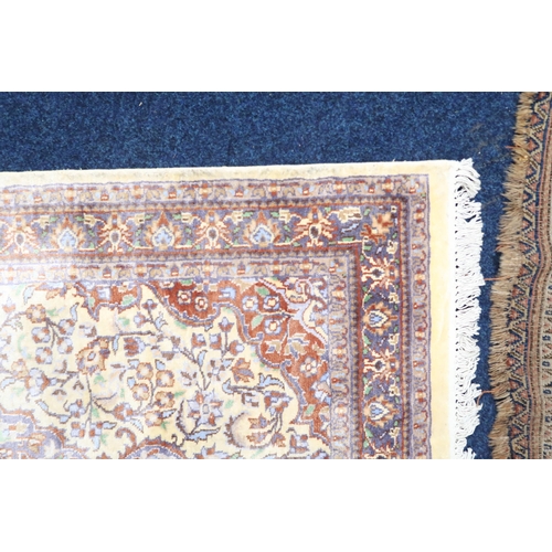 29 - A cream ground Isfahan style rug with ochre central medallion and matching spandrels on floral patte... 