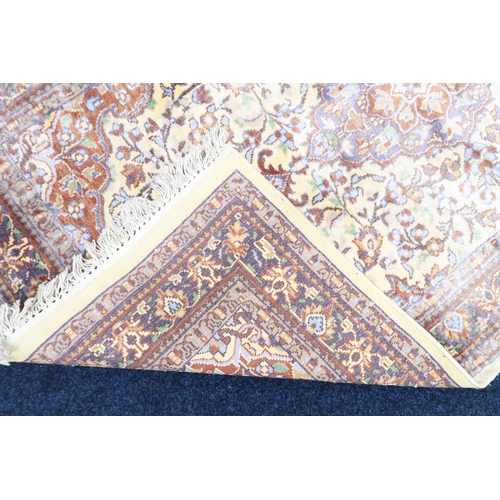 29 - A cream ground Isfahan style rug with ochre central medallion and matching spandrels on floral patte... 