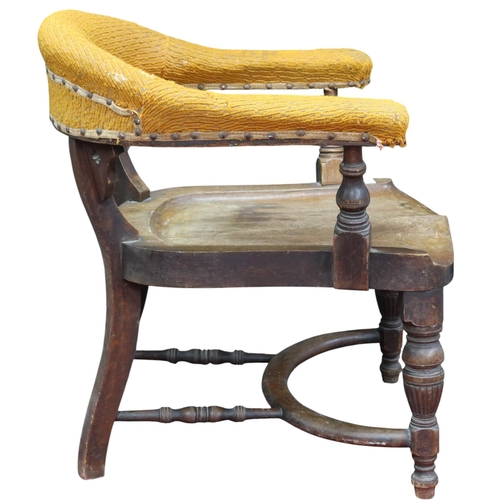 8 - A Victorian oak horseshoe back captains style desk chair with shaped upholstered arms and backrest o... 