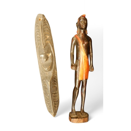 161 - Four African carved wood wall masks and a carved figure