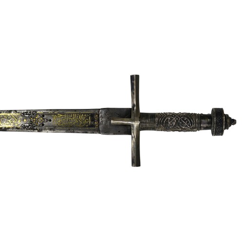 2667 - A NORTHEAST AFRICAN KASKARA SWORDThe Damascene blade inlaid with yellow metal Arabic script along it...