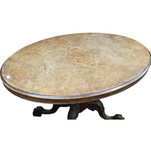 28 - A Victorian burr walnut quarter veneered oval tilt top breakfast table on turned supports on quadrup... 