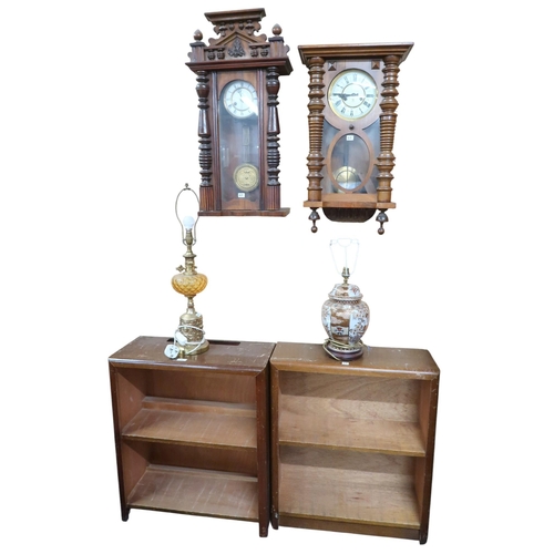60 - A lot comprising two mid 20th century open bookcases, two assorted Austrian style wall clocks and tw... 
