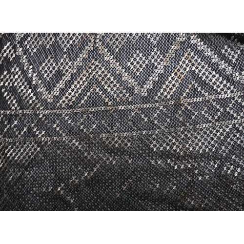 245A - An Egyptian Assuit white metal and black net shawl