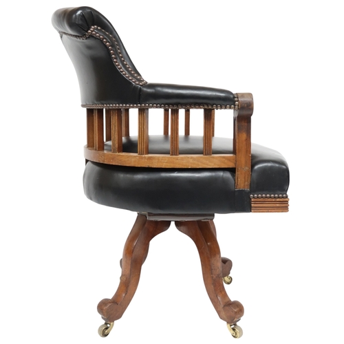 2016 - AN EARLY 20TH CENTURY BEECH FRAMED CAPTAINS STYLE SWIVEL DESK CHAIR&nbsp;with black Rexine upholster... 