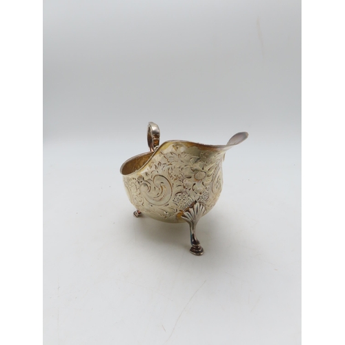 285 - A silver sauceboat, by  Atkins Brothers Ltd, Sheffield 1902, with embossed scrolling foliate decorat... 