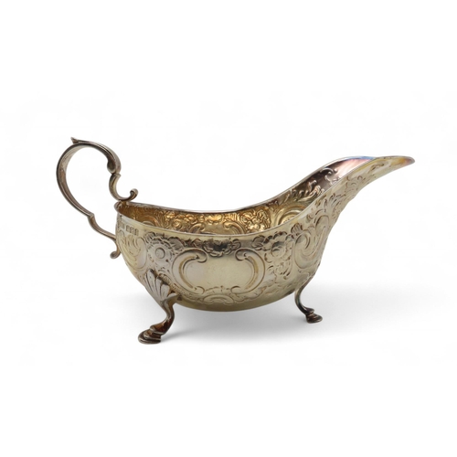 285 - A silver sauceboat, by  Atkins Brothers Ltd, Sheffield 1902, with embossed scrolling foliate decorat... 
