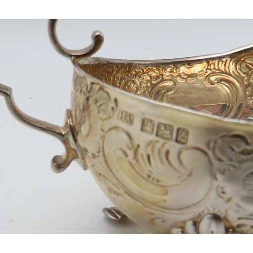 285 - A silver sauceboat, by  Atkins Brothers Ltd, Sheffield 1902, with embossed scrolling foliate decorat... 