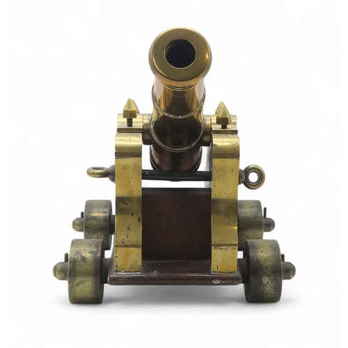 2550 - A BRASS MARITIME SIGNAL CANNONMounted upon a hardwood carriage, the barrel measuring approx. 59cm fr... 