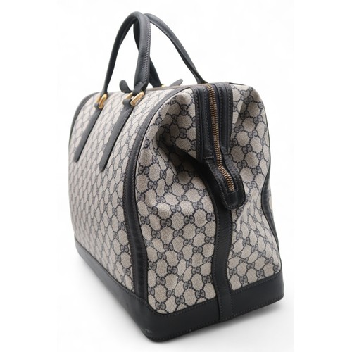 6141 - Gucci - A travel bag with navy leather trim43cm long x 32cm high x 22cm wide