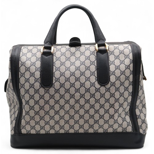 6141 - Gucci - A travel bag with navy leather trim43cm long x 32cm high x 22cm wide