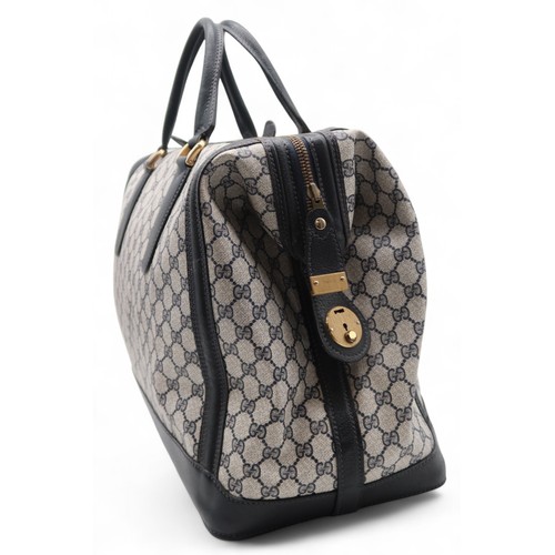 6141 - Gucci - A travel bag with navy leather trim43cm long x 32cm high x 22cm wide