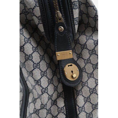 6141 - Gucci - A travel bag with navy leather trim43cm long x 32cm high x 22cm wide