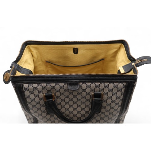6141 - Gucci - A travel bag with navy leather trim43cm long x 32cm high x 22cm wide