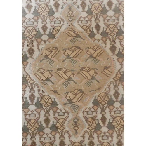 33 - A beige ground Persian Kilim rug with diamond form central medallion and matching spandrels on geome... 