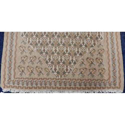 33 - A beige ground Persian Kilim rug with diamond form central medallion and matching spandrels on geome... 