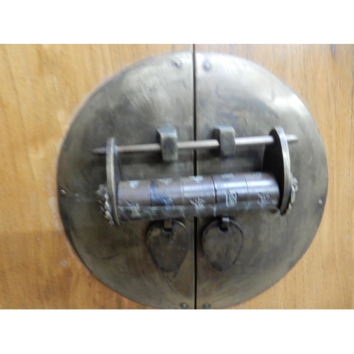 35 - A 20th century Chinese elm altar style side cabinet with upturned top over two short drawers and pai... 