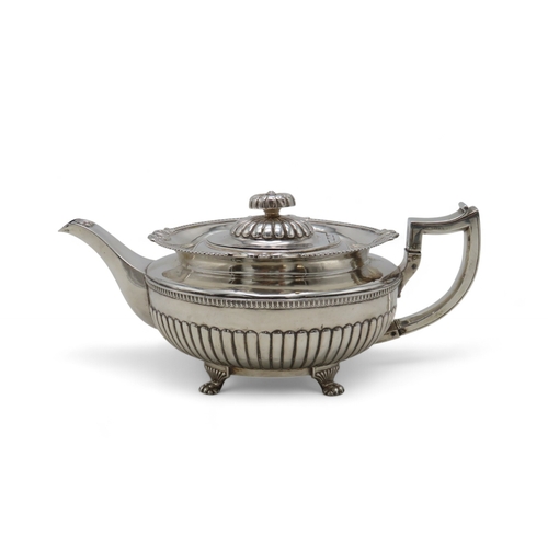 2302 - A GEORGE III IRISH SILVER TEAPOTby James Scott, Dublin 1814, of squat baluster form, the body part-f... 