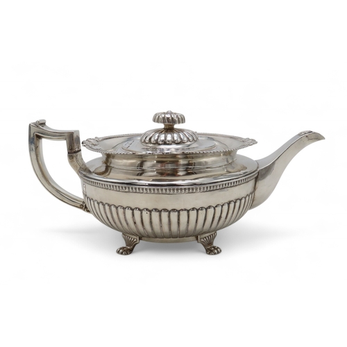 2302 - A GEORGE III IRISH SILVER TEAPOTby James Scott, Dublin 1814, of squat baluster form, the body part-f... 