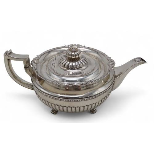 2302 - A GEORGE III IRISH SILVER TEAPOTby James Scott, Dublin 1814, of squat baluster form, the body part-f... 