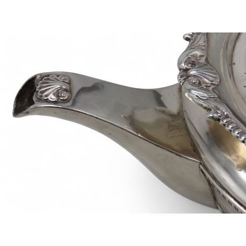 2302 - A GEORGE III IRISH SILVER TEAPOTby James Scott, Dublin 1814, of squat baluster form, the body part-f... 