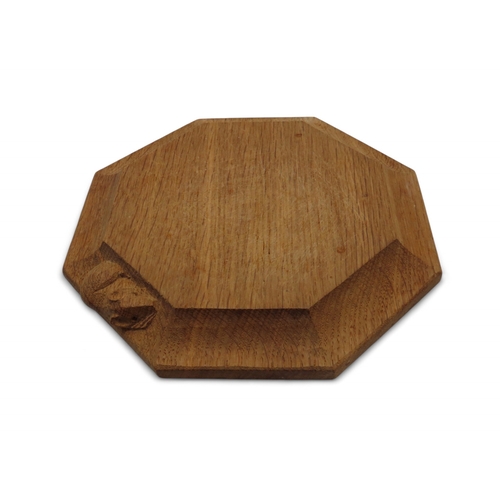 2153 - WORKSHOP OF ROBERT 'MOUSEMAN' THOMPSON, KILBURNoak octagonal chopping board, with carved mouse detai... 