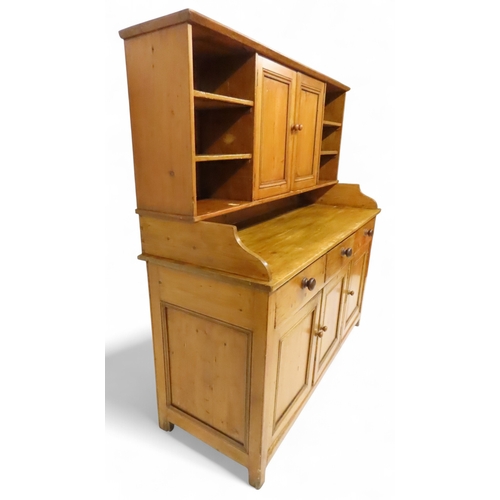 2003 - A 19TH CENTURY SCOTTISH PINE FARM HOUSE KITCHEN DRESSERwith central pair of cabinet doors flanked by... 