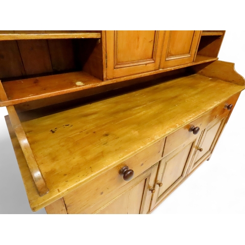 2003 - A 19TH CENTURY SCOTTISH PINE FARM HOUSE KITCHEN DRESSERwith central pair of cabinet doors flanked by... 