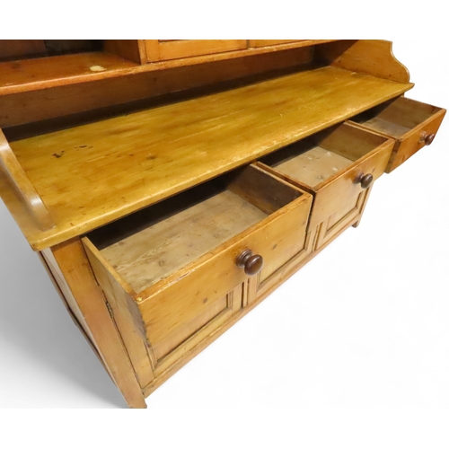 2003 - A 19TH CENTURY SCOTTISH PINE FARM HOUSE KITCHEN DRESSERwith central pair of cabinet doors flanked by... 