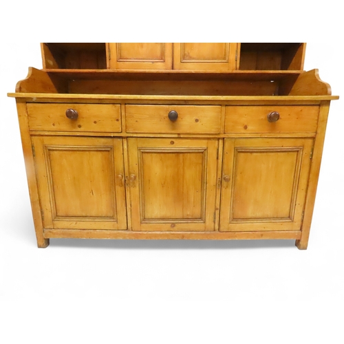 2003 - A 19TH CENTURY SCOTTISH PINE FARM HOUSE KITCHEN DRESSERwith central pair of cabinet doors flanked by... 