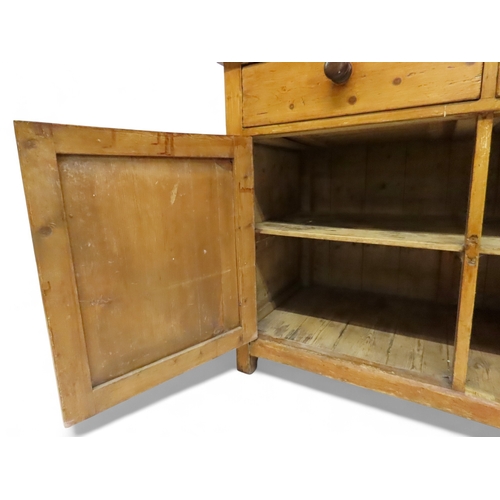 2003 - A 19TH CENTURY SCOTTISH PINE FARM HOUSE KITCHEN DRESSERwith central pair of cabinet doors flanked by... 