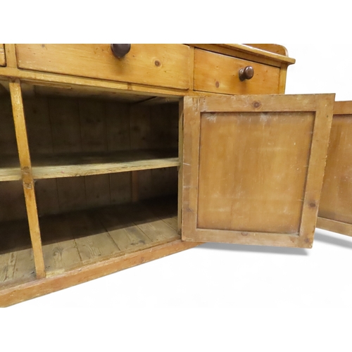 2003 - A 19TH CENTURY SCOTTISH PINE FARM HOUSE KITCHEN DRESSERwith central pair of cabinet doors flanked by... 