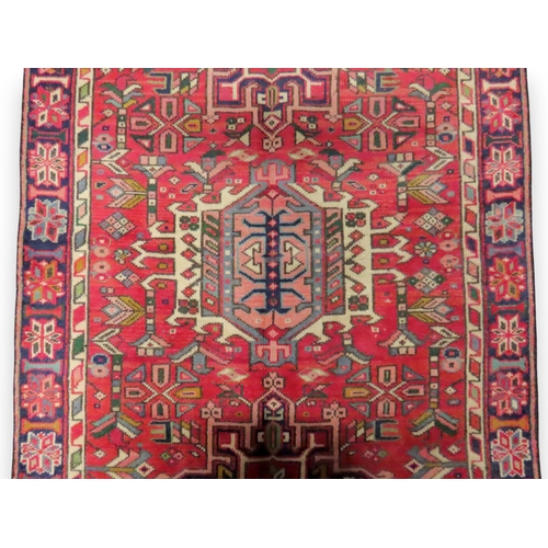 A RED GROUND KARAJEH RUNNERwith seven assorted multicoloured geometric ...